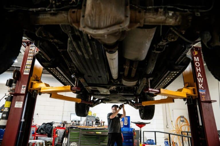 Repair technician under car